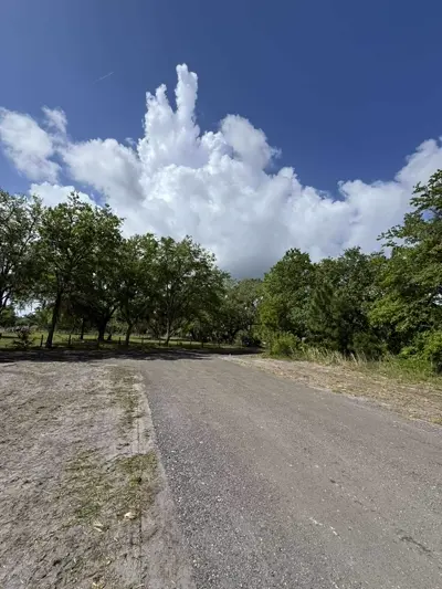 Skid steer performing site grading on a construction site in Central Florida