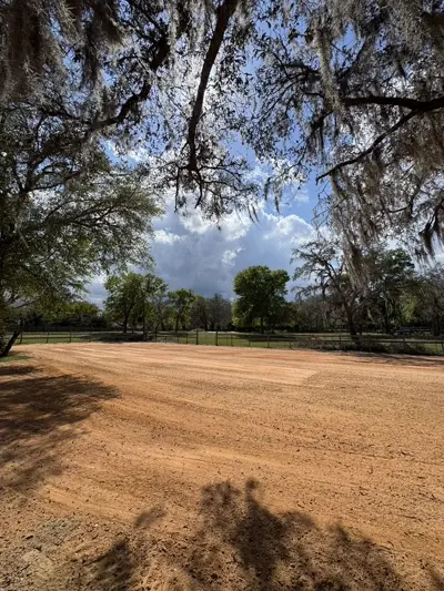 Horse arena preparation with clay mix being worked into sandy soil by Dirt Dynamics
