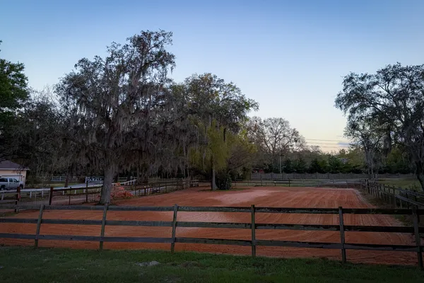 Wide view of a horse arena prepared with clay-sand mix by Dirt Dynamics LLC in Central Florida